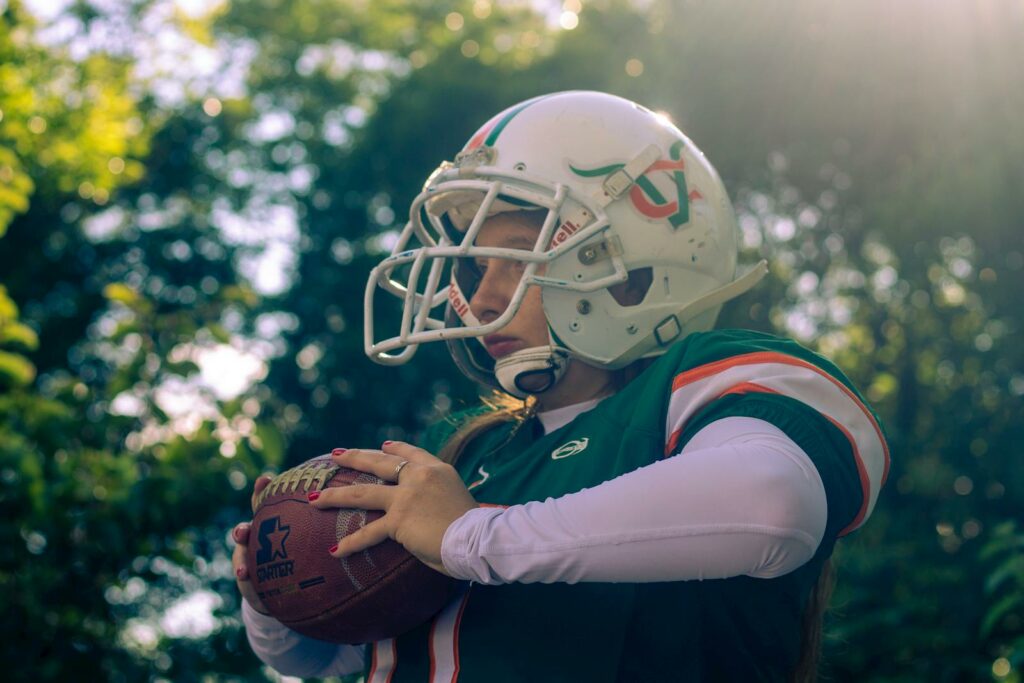 Woman in Uniform Playing American Football