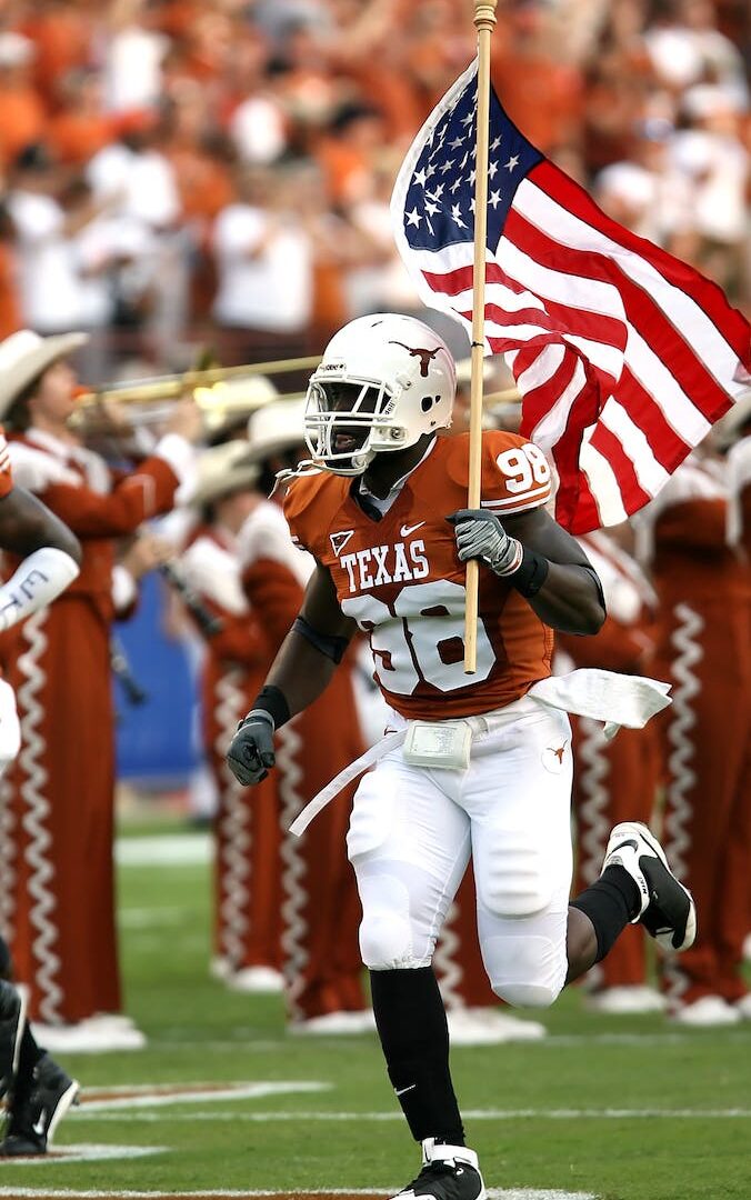 Nfl Player Holding U.s.a. Flag on Field