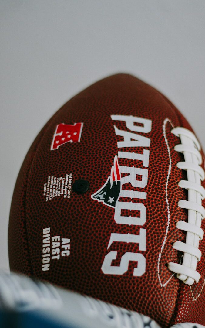 red and white football on white surface